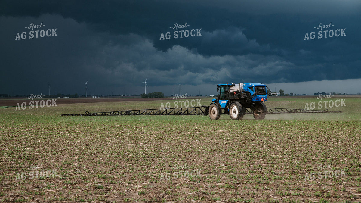 New Holland Self-Propelled Sprayer Working Fields Ahead of an Approaching Storm 401006