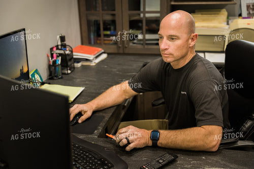 Farmer Works on Computer in Office 7492