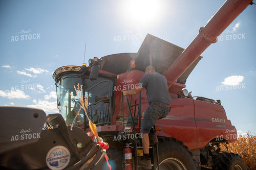 Farmer Climbing into Combine 25885