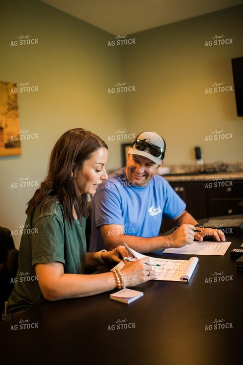 Husband and Wife Farmers Going Over Paperwork 6179