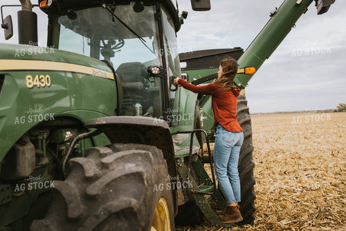 Female Farmer Cimbing into Tractor 8551