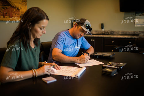 Husband and Wife Farmers Going Over Paperwork 6176