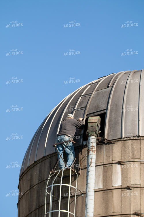Farmer Climbing Silo 157239