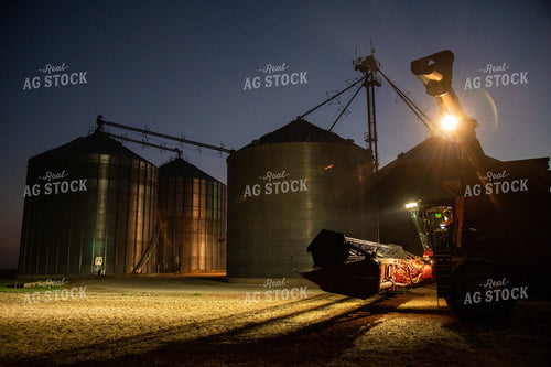 Farmer Sitting in Combine at Night 25802