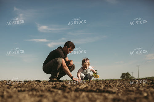 Farmer and Daughter Checking Seed Depth 4176
