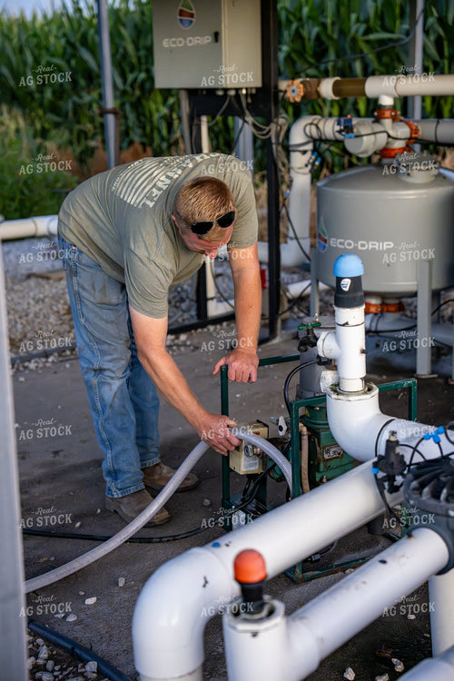 Farmer Working On Drip Irrigation System 65935
