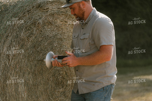 Farmer Checking Hay Moisture 125392