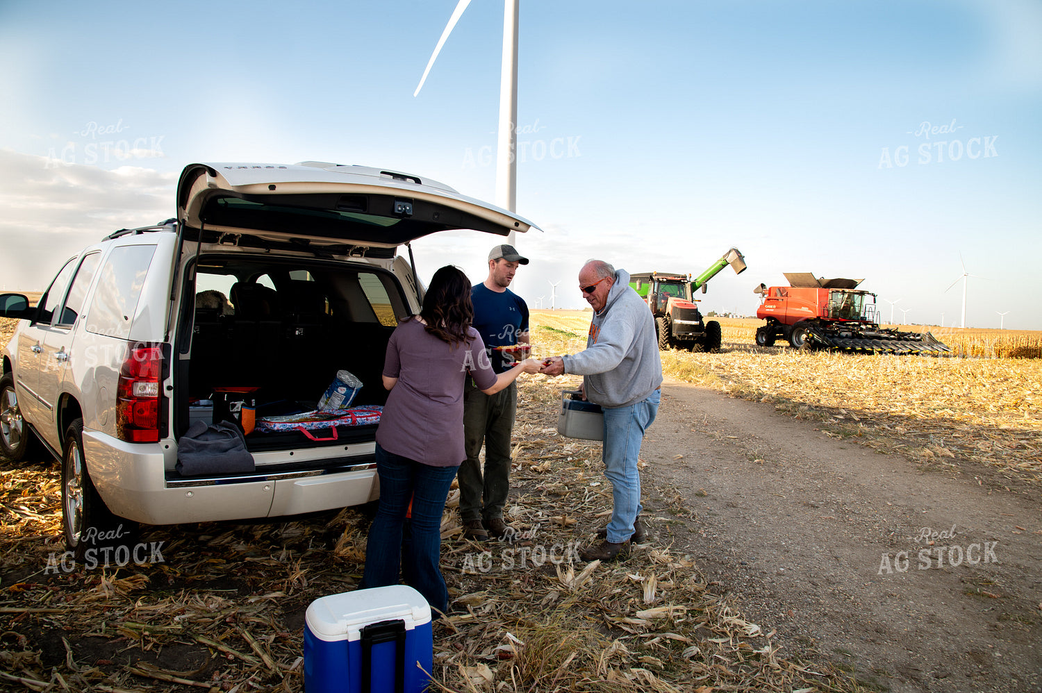 Family Enjoying Harvest Meal in the Field 25814