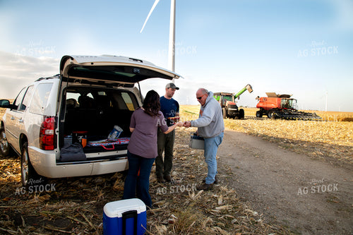 Family Enjoying Harvest Meal in the Field 25814