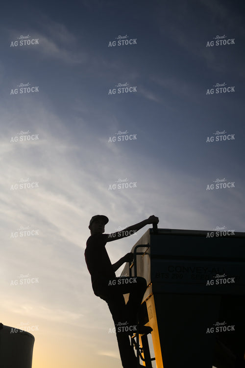 Farmer Climbing up Seed Tender 191009