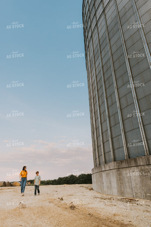 Farm Wife and Son Walk by Grain Bin 7800
