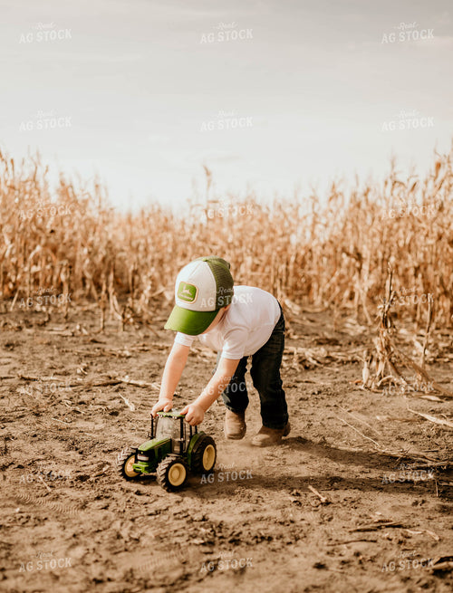 Farm Kid Playing with Toy Tractors 185076